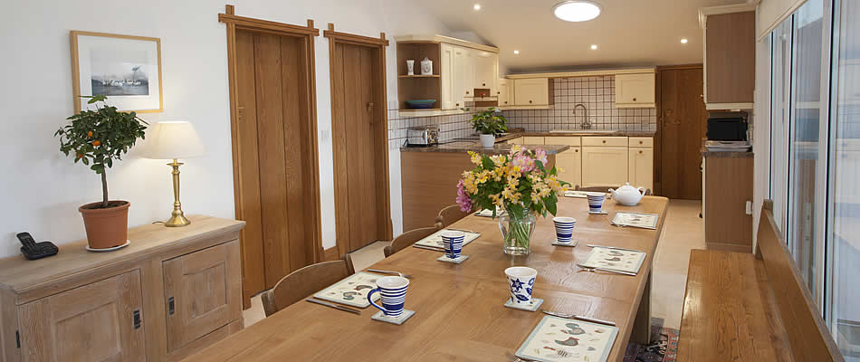 Open plan kitchen area with large dining table