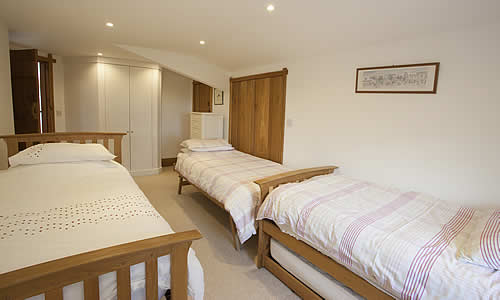 Twin bedroom with additional truckle beds, making 4 beds in all